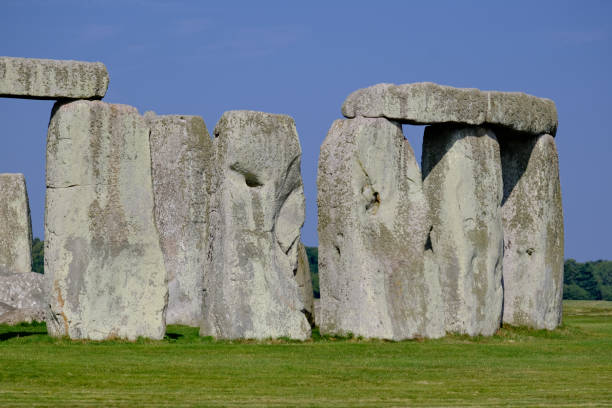 Stonehenge, Wiltshire, United Kingdom, August 30, 2024. Atmospheric ancient neolithic stone circle or monument. Focus on the outer ring of Sarsen Stones. Outdoors on a sunny summer day.
