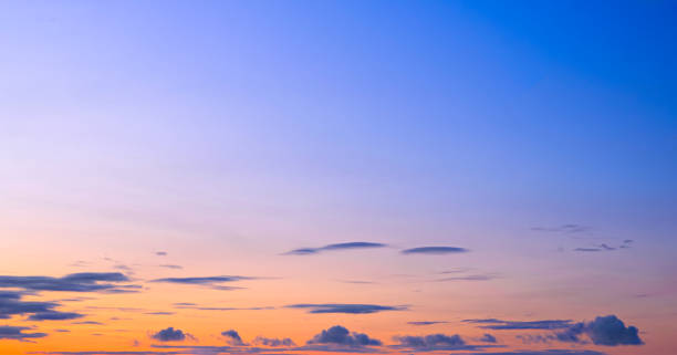 istock Sunset sky background with dark clouds and natural gradient light on horizon orange and blue evening sky 2169609644