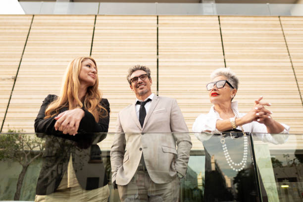 istock Business people leaning on railing and looking away 2169610159