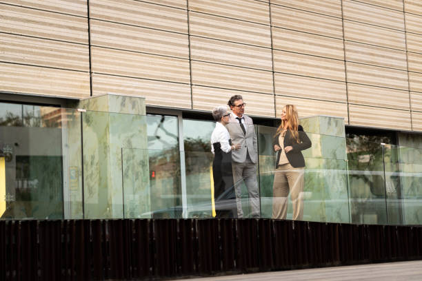 istock Business people talking during break outside office building 2169610292