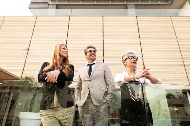 istock Business people leaning on railing and looking away 2169610413