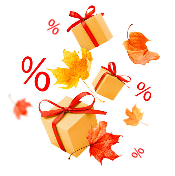 Gift boxes, autumn leaves and percent signs on white isolated background. Autumn sale and discounts
