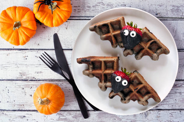 istock Fun Halloween chocolate bat waffles on a rustic white wood table 2169613623