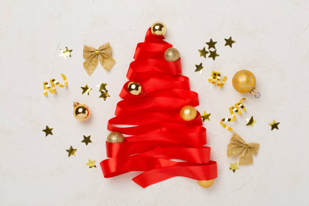 istock Creative ribbon christmas tree with decor on concrete background, top, view 2169618131
