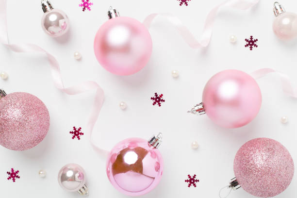 istock Pink christmas balls with decor on color background, top view 2169618162