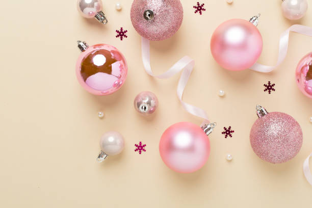 istock Pink christmas balls with decor on color background, top view 2169618167