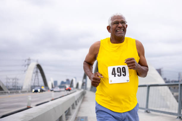 istock Senior black man running in a marathon 2169620547