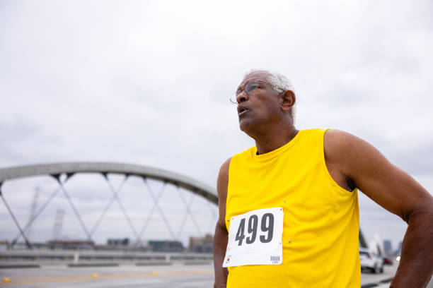 istock Senior black man running in a marathon 2169620597