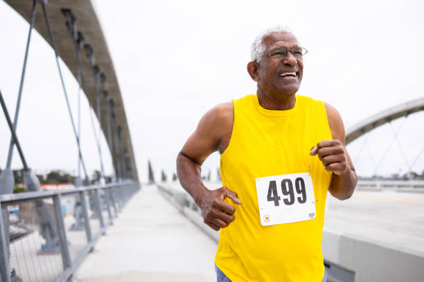 istock Senior black man running in a marathon 2169620651