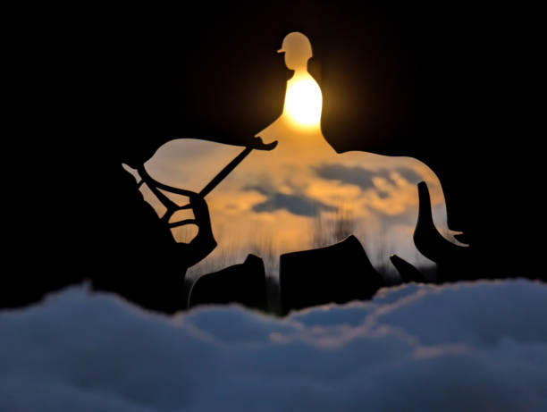 Sun sets through a horseback riding silhouette