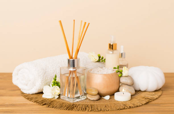 istock Spa composition with freesia flower and aroma diffuser on wooden table 2169624143
