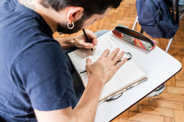istock Close-up of a student taking notes in the classroom 2169625422