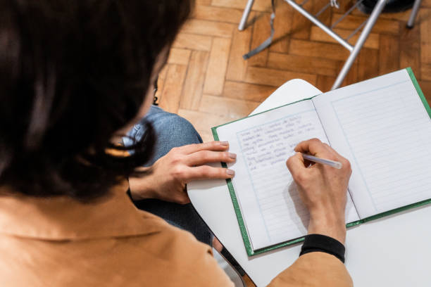 istock Close-up of a student taking notes in the classroom 2169625524