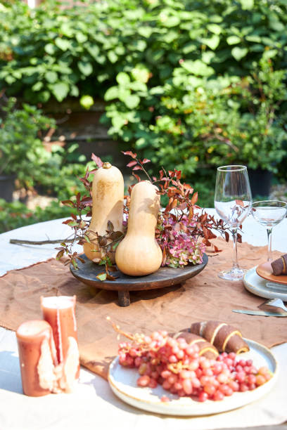 istock Fall table setting with pumpkins and leaves and hydrangea in brown and burgundy tones 2169626426