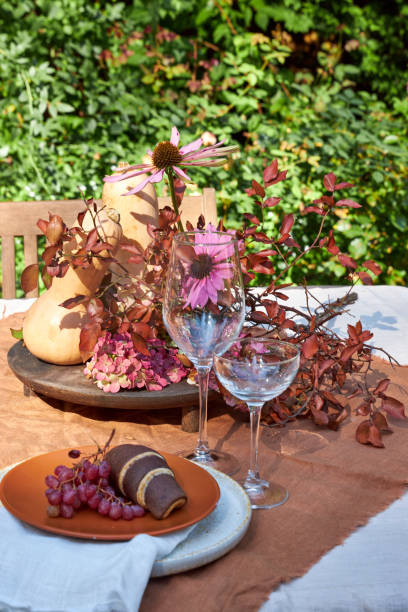istock Fall table setting with pumpkins and leaves and hydrangea in brown and burgundy tones 2169626614