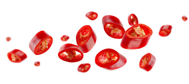 istock Red hot sliced chili pepper flies and levitates in space. Volumetric light from behind. Isolated on white. Full depth of field 2169629511