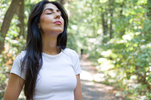 istock Relaxed woman breathing fresh air in the spring forest 2169630694