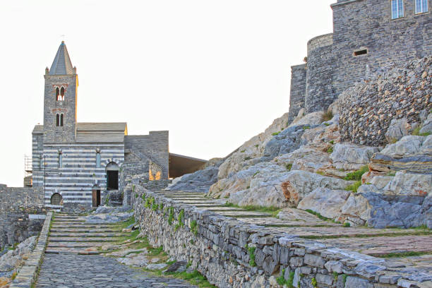 Porto Venere, Italy - October 02, 2009: Stone Bell Tower at Historic Saint Peter Church at Liguria Coast Rocks Autumn Afternoon.