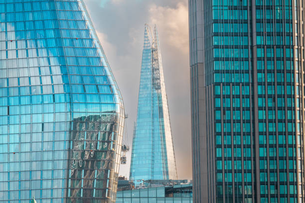 The bell tower of a church reflected on the facade of a skyscraper building in the downtown district of Montreal