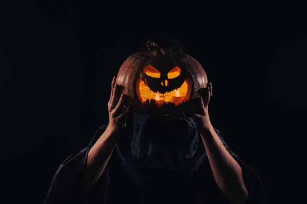 istock Pumpkin jack o lantern instead of a woman's head. Halloween 2169657242