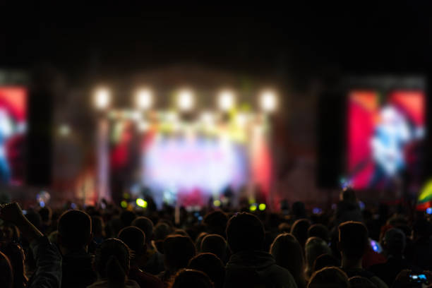 istock Crowd at a concert, back light silhouette 2169658374
