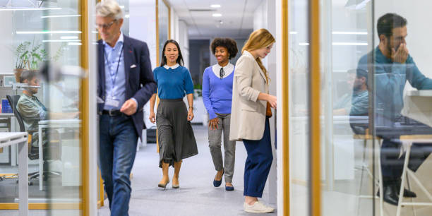 istock Diverse Business Professionals Walking in Office Corridor 2169658706