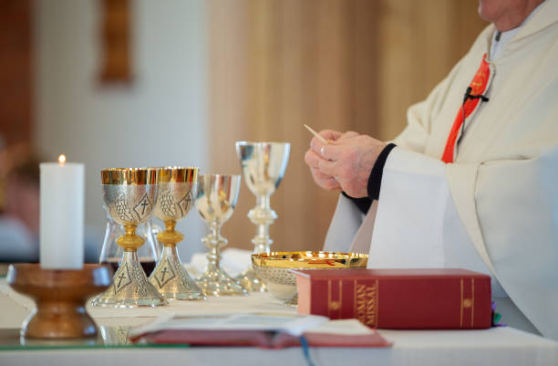 istock Catholic priest performing the sacrement of the Eucharist 2169660942