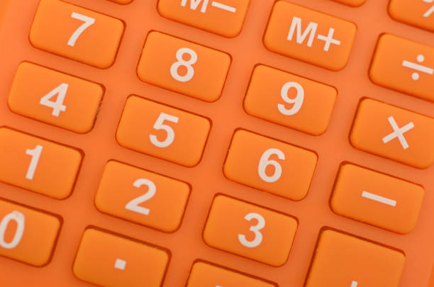 a close-up of an orange calculator, highlighting the numerical keys and basic arithmetic functions commonly used in everyday calculations.