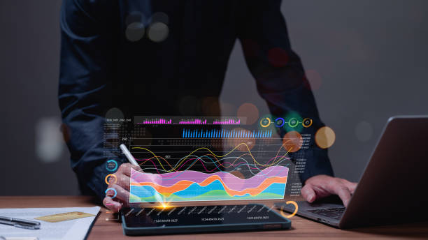 Professional businessman, holding tablet, points at a graph on screen, analyzing financial growth and using technology to interpret key business information from the diagram for strategic planning