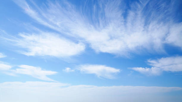 istock Blue autumn sky with white clouds drifting by 2169664623