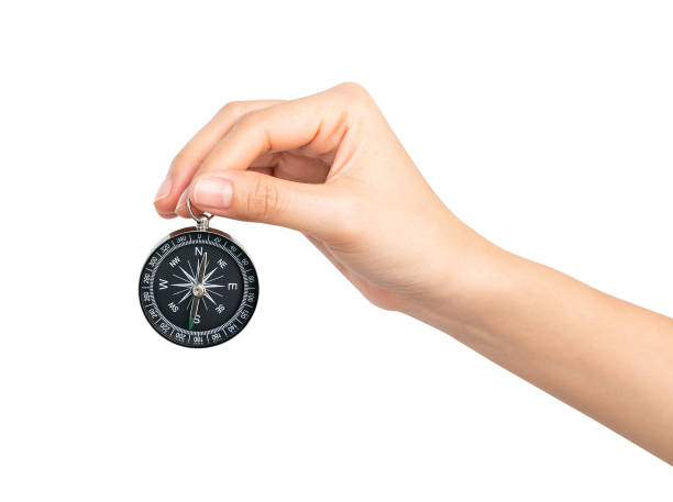istock Clipping path, hand holding compass on isolated white background. 2169669227