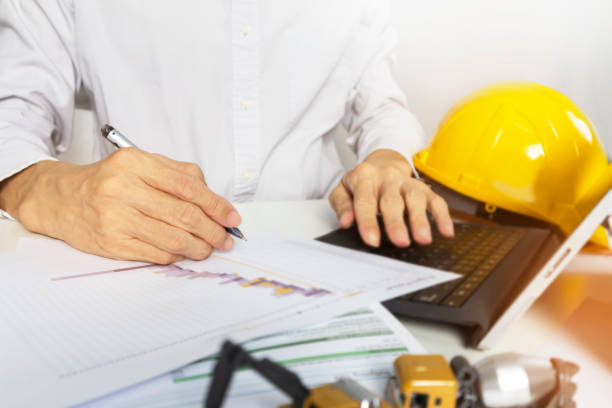 istock A businessman who is a construction engineer verifies that the work schedule and building guidelines align with the business plan. 2169670539