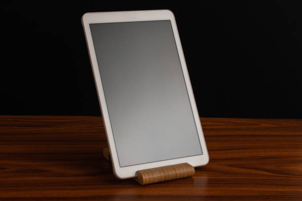 istock White advanced smart home control panel mounted on a wooden base and dark background. 2169673185