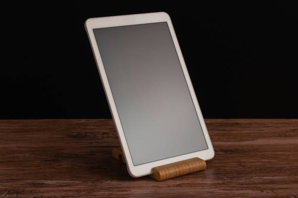 istock White advanced smart home control panel mounted on a wooden base and dark background. 2169673196