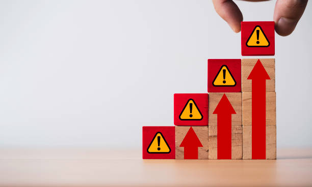 istock Hand putting exclamation waring and caution sign symbol on red up arrow for high risk and notification error maintenance concept. 2169682952