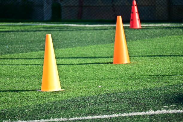 istock artificial green grass soccer field with orange training cones 2169685013