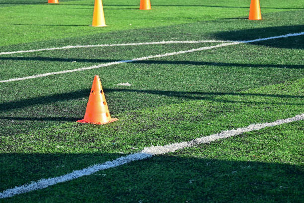 istock artificial green grass soccer field with orange training cones 2169686233