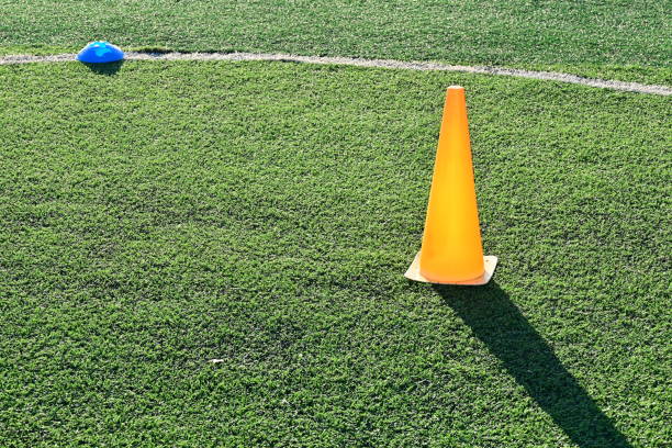 istock artificial green grass soccer field with orange training cones 2169686239