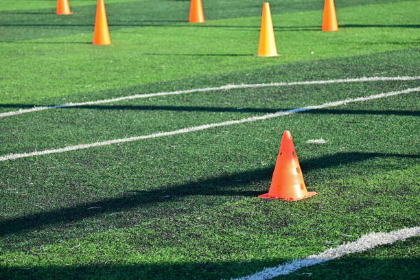 istock artificial green grass soccer field with orange training cones 2169686434