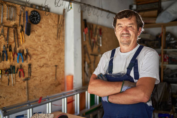 istock Senior man repairing staff in garage 2169686953