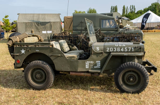 Side on view of military jeep Forncett St Peter, Norfolk, UK - August 18 2024. Close up of a vintage military jeep on display at a public exhibition and world war re-enactment jeep 4x4 off road vehicle world war ii stock pictures, royalty-free photos & images