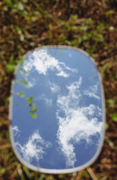 istock Round mirror lying in green grass with copy space. Grass and sky reflection in the mirror. Ecology concept. Mirror on green lawn. Nature fragility. Summer landscape in the mirror. 2169689040