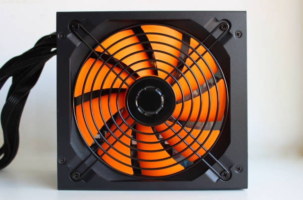 istock Computer power supply with a powerful fan in a black case on a white table 2169691733