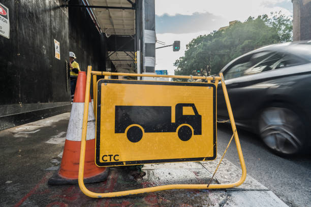 Sydney, NSW, Australia, February 19th 2024. A construction sign indicating truck access alongside a traffic cone on a street.