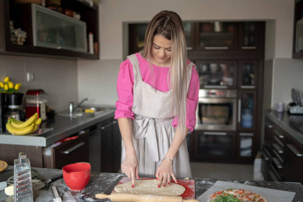 istock Woman preparing doughty for pizza 2169699730