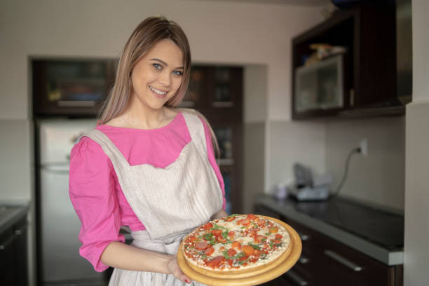 istock Woman preparing doughty for pizza 2169699786