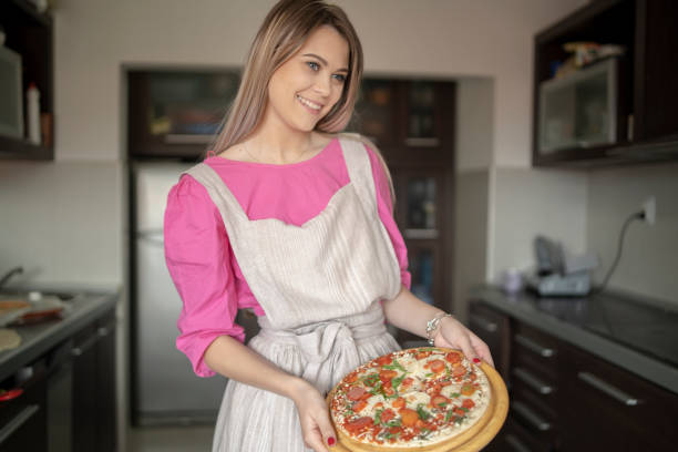 istock Woman preparing doughty for pizza 2169699797