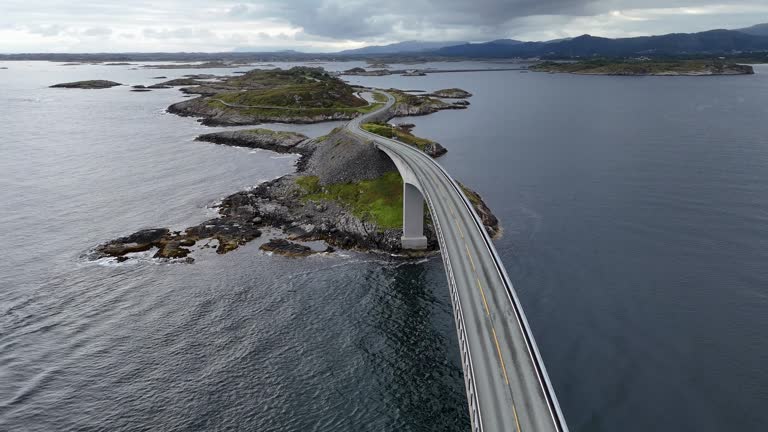 Vehicles Travel Across a Bridge on the Atlantic Ocean Road, Aerial Drone View in Norway in 4K.