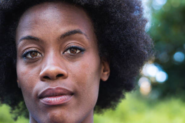 Black female with Afro hairstyle looking at camera