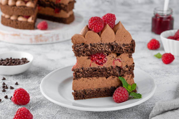 istock Naked chocolate raspberry cake with chocolate cream filling on a board on a concrete background. 2169704562
